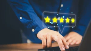 Person Giving 5-Star Rating On Laptop