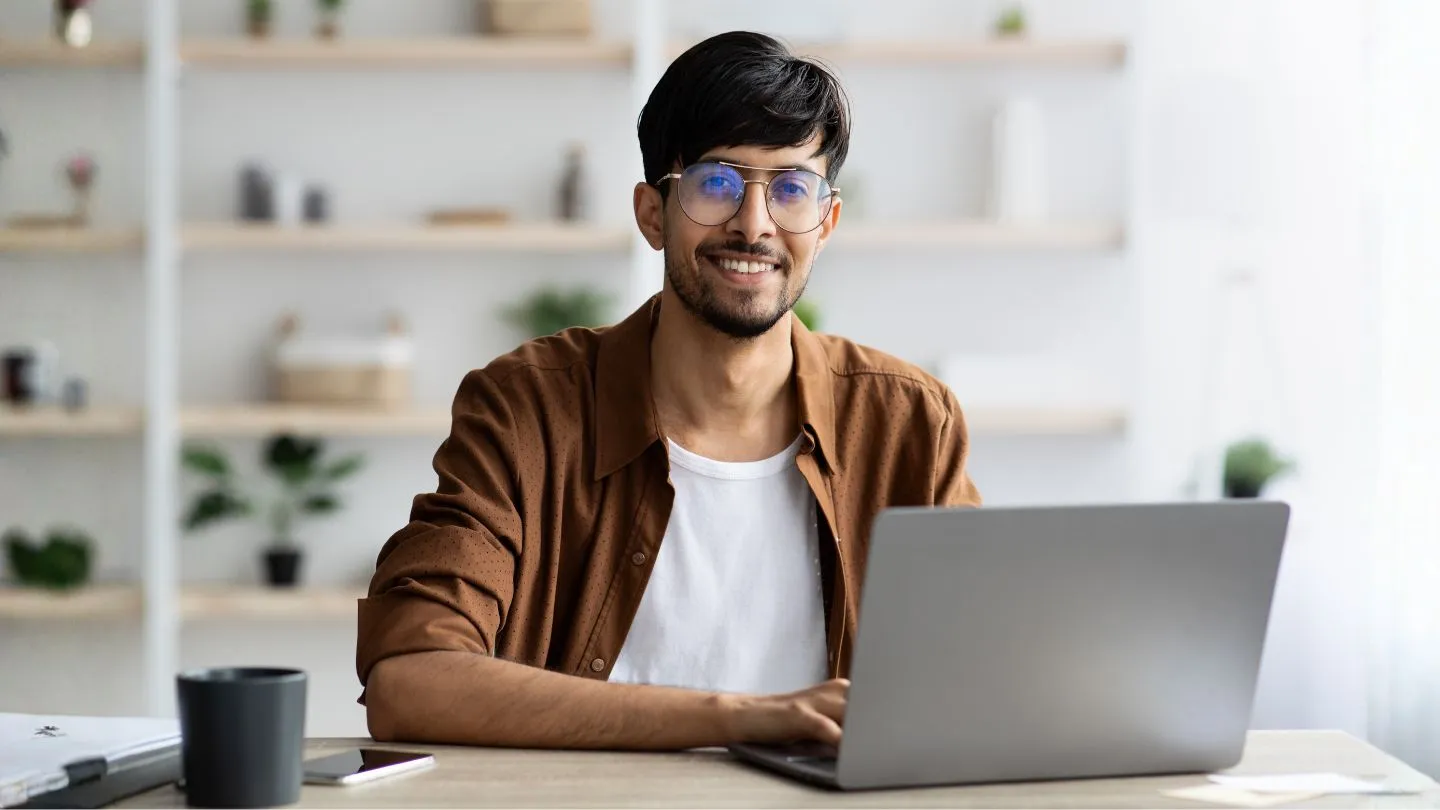Man Working on Laptop at Home Office