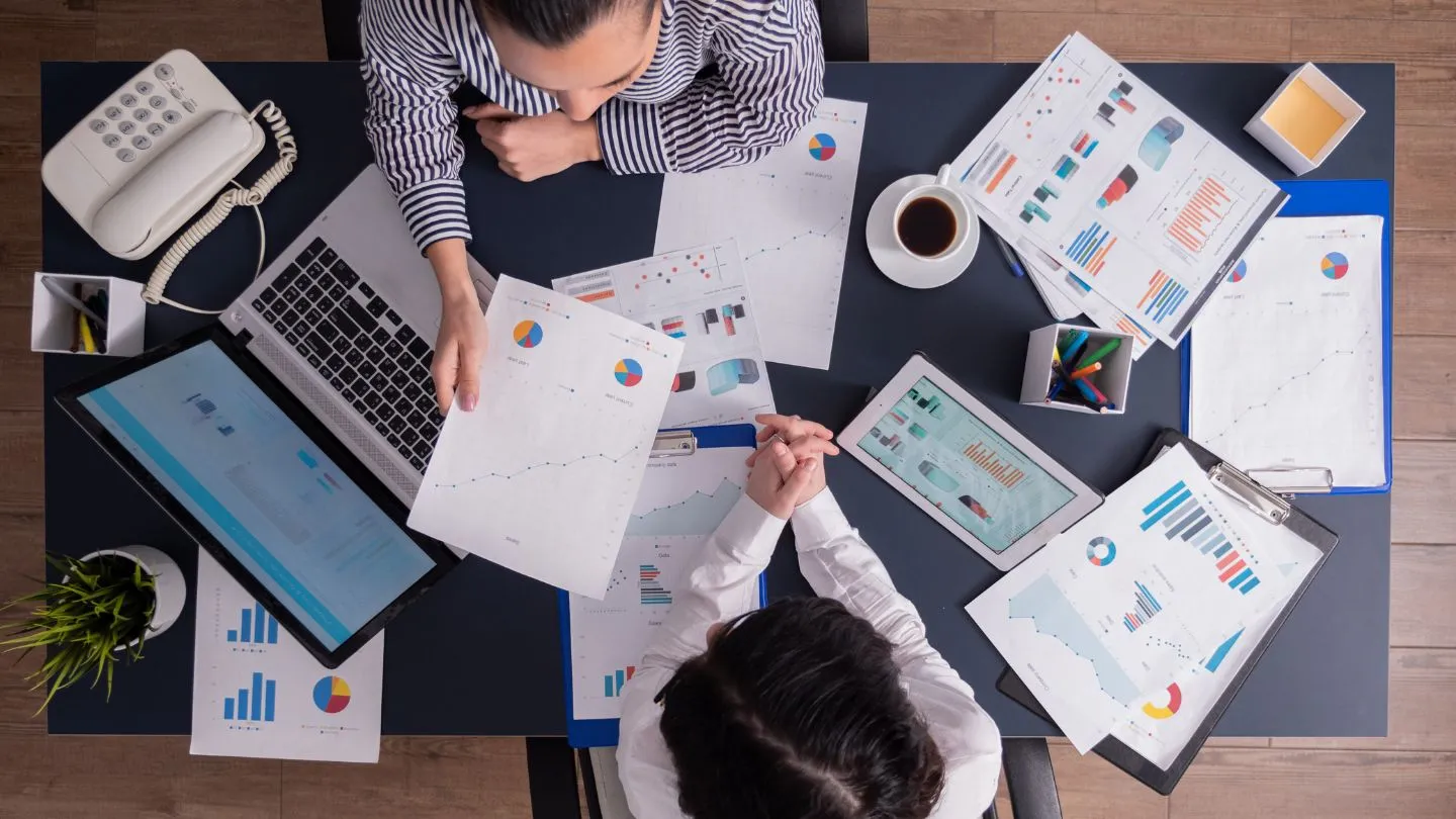 Team Reviewing Analytics Reports at Office Desk